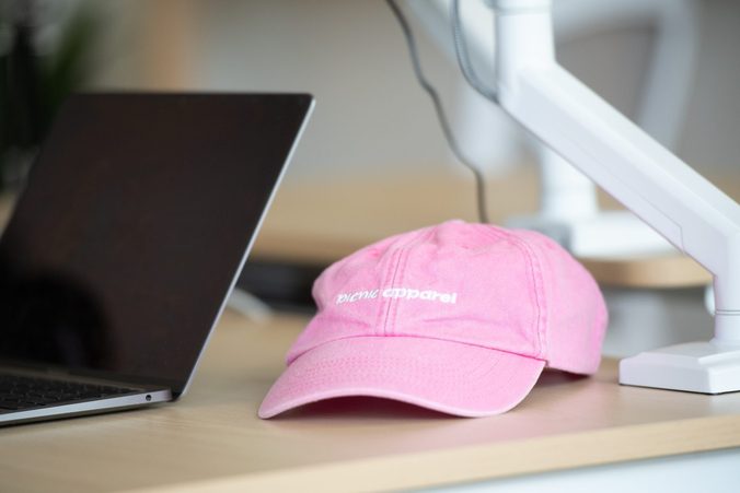 A Picnic branded cap on a desk in the office